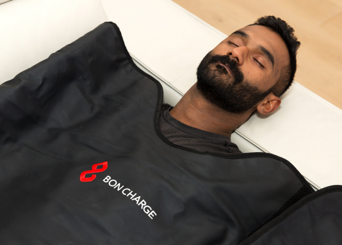 A man enjoying an infrared sauna blanket session